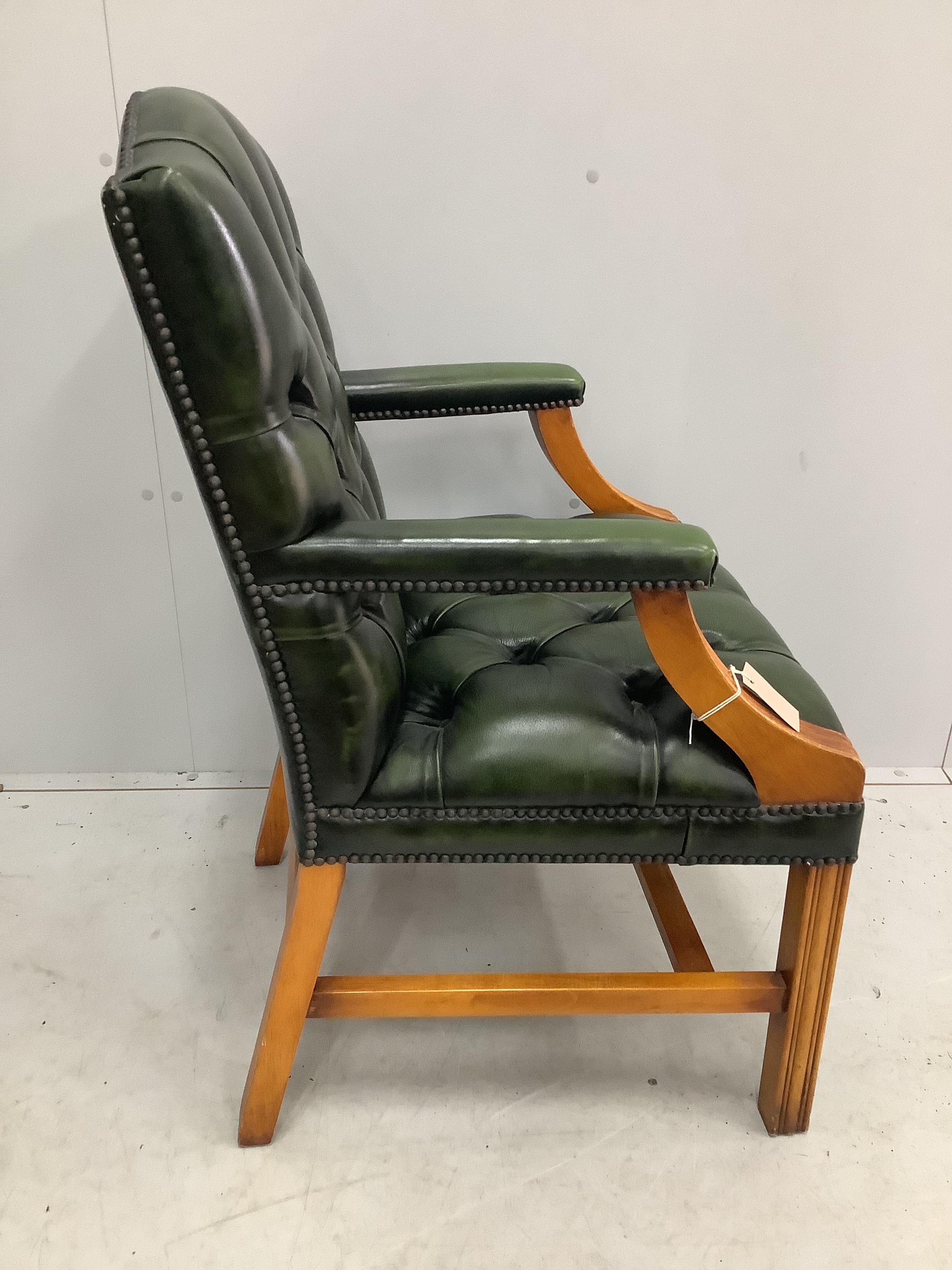 A reproduction buttoned green leather Gainsborough style desk chair, width 59cm, depth 52cm, height 101cm